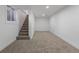 Finished basement featuring neutral carpet and a staircase with a window for natural light at 1670 S Quieto Ct, Denver, CO 80223