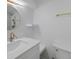 Well-lit bathroom featuring modern vanity, round mirror, and gold fixtures adding a touch of elegance at 1670 S Quieto Ct, Denver, CO 80223