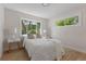 Bright bedroom with hardwood floors, crisp white walls, and well-lit by the many windows at 1670 S Quieto Ct, Denver, CO 80223