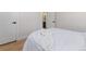 Neutral bedroom featuring a large bed with hardwood flooring and an ensuite bathroom at 1670 S Quieto Ct, Denver, CO 80223