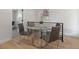 Bright dining area features a modern glass table and stylish chairs, perfect for casual meals at 1670 S Quieto Ct, Denver, CO 80223