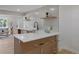 Open-concept kitchen with quartz countertops, bar seating, and stylish fixtures, perfect for entertaining at 1670 S Quieto Ct, Denver, CO 80223