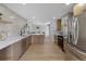 Spacious kitchen featuring light wood cabinetry, quartz countertops, and stainless steel appliances at 1670 S Quieto Ct, Denver, CO 80223