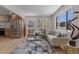 Bright living room with stylish furniture, a large window, and hardwood floors, creating a welcoming atmosphere at 1670 S Quieto Ct, Denver, CO 80223