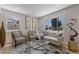 Bright living room with stylish furniture, a large window, and hardwood floors, creating a welcoming atmosphere at 1670 S Quieto Ct, Denver, CO 80223