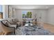 Bright living room with stylish furniture, a large window, and hardwood floors, creating a welcoming atmosphere at 1670 S Quieto Ct, Denver, CO 80223
