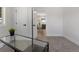 Home office leading into a dining area, with carpet, neutral colors, and natural light at 1670 S Quieto Ct, Denver, CO 80223
