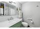 Bathroom with a marble countertop, green vanity, and a shower and toilet at 2140 S Youngfield St, Lakewood, CO 80228