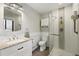 Modern bathroom with a glass shower, granite countertop, and sleek white fixtures at 2140 S Youngfield St, Lakewood, CO 80228