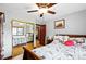 Spacious bedroom features hardwood floors, ceiling fan, closet with mirrors and natural light at 2140 S Youngfield St, Lakewood, CO 80228