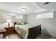 Comfortable bedroom with two windows for natural light, and a dark wood bed frame at 2140 S Youngfield St, Lakewood, CO 80228