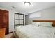 Well-lit bedroom featuring a queen bed with neutral comforter and an accent wall at 2140 S Youngfield St, Lakewood, CO 80228