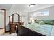 Bedroom with a large vanity and a comfortable bed with decorative pillows and bedspread at 2140 S Youngfield St, Lakewood, CO 80228