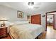 Comfortable bedroom with a ceiling fan, hardwood floors and traditional wooden closet at 2140 S Youngfield St, Lakewood, CO 80228