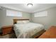 Bedroom featuring a queen bed with neutral comforter, and windows on two walls at 2140 S Youngfield St, Lakewood, CO 80228