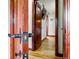 Hallway with hardwood floors, wood trim and doors, and a view into other rooms at 2140 S Youngfield St, Lakewood, CO 80228