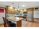Bright and modern kitchen features stainless steel appliances and bar stool seating at 2140 S Youngfield St, Lakewood, CO 80228