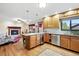 Eat-in kitchen with wood cabinets, stainless appliances, and an island at 2140 S Youngfield St, Lakewood, CO 80228