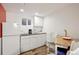 Cozy kitchenette featuring white cabinets, stainless appliances, and a breakfast table at 2140 S Youngfield St, Lakewood, CO 80228