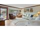 Bright living room with hardwood floors, white couches and large windows at 2140 S Youngfield St, Lakewood, CO 80228