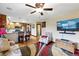 Spacious living room open to the kitchen featuring a ceiling fan and tv at 2140 S Youngfield St, Lakewood, CO 80228