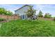 Expansive backyard with green grass, a storage shed, and wooden fence for added privacy at 5864 Turnstone Pl, Castle Rock, CO 80104