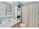Bathroom with toilet, vanity with sink and medicine cabinet with shower/tub combo at 5864 Turnstone Pl, Castle Rock, CO 80104