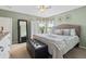 Well-lit bedroom with a queen-sized bed, large mirror, and neutral color scheme at 5864 Turnstone Pl, Castle Rock, CO 80104