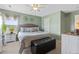 Tranquil bedroom with a queen-sized bed, ample natural light, ceiling fan, and neutral color scheme at 5864 Turnstone Pl, Castle Rock, CO 80104