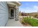 Welcoming front entrance featuring stone pillars, landscaped garden and a cozy outdoor space for relaxation at 5864 Turnstone Pl, Castle Rock, CO 80104