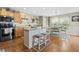 Bright and airy kitchen featuring wooden cabinets, an island with seating, and stainless steel appliances at 5864 Turnstone Pl, Castle Rock, CO 80104