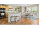 Charming kitchen with an island, stainless steel appliances, and a dining area with access to outdoor views, creating a warm space at 5864 Turnstone Pl, Castle Rock, CO 80104
