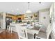 Eat-in kitchen features a dining area with wood floors, modern appliances, and updated cabinets and island with breakfast bar at 5864 Turnstone Pl, Castle Rock, CO 80104