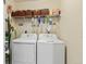 Laundry room features washer and dryer with shelving above at 5864 Turnstone Pl, Castle Rock, CO 80104
