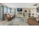 Comfortable living room with a leather sofa, stylish rug, and a modern TV setup, creating a relaxing atmosphere at 5864 Turnstone Pl, Castle Rock, CO 80104