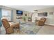 The comfortable living room boasts dual leather sofas, a stylish rug, tv, and contemporary decorations at 5864 Turnstone Pl, Castle Rock, CO 80104