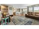 Open-concept floorplan features a living room and eat-in kitchen with modern furniture and natural light at 5864 Turnstone Pl, Castle Rock, CO 80104