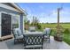 Cozy patio with stylish furniture, string lights, and a beautiful view of the green lawn at 5864 Turnstone Pl, Castle Rock, CO 80104