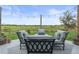 Inviting outdoor patio area with comfortable seating and string lights, perfect for relaxing and entertaining with a beautiful view at 5864 Turnstone Pl, Castle Rock, CO 80104