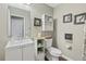 Charming half-bathroom features a vanity sink, toilet, and stylish décor with modern fixtures at 5864 Turnstone Pl, Castle Rock, CO 80104