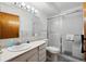 Bright bathroom featuring a shower with sliding doors and modern fixtures at 710 S Clinton St # 1A, Denver, CO 80247