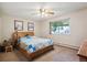 A cozy bedroom featuring a wooden bed frame with a window offering natural light at 710 S Clinton St # 1A, Denver, CO 80247