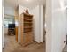 Hallway view with a bookcase, partial view of the living room, and neutral decor at 710 S Clinton St # 1A, Denver, CO 80247