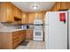Cozy kitchen featuring wooden cabinets, neutral countertops, and essential appliances at 710 S Clinton St # 1A, Denver, CO 80247