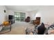 Bright living area with large window and neutral carpet, featuring comfortable seating at 710 S Clinton St # 1A, Denver, CO 80247