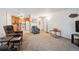 Inviting living room showing kitchen view, carpeted floors and comfortable furnishings at 710 S Clinton St # 1A, Denver, CO 80247