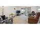 Spacious living room with sliding glass doors to balcony, neutral carpet, and ample seating at 710 S Clinton St # 1A, Denver, CO 80247