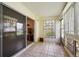 Enclosed porch with tile flooring and decorative brick wall, ideal for relaxation at 710 S Clinton St # 1A, Denver, CO 80247