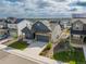 Aerial front view of a two-story house, landscaped yard, driveway, and charming exterior architectural elements at 8132 Mt Harvard Rd, Littleton, CO 80125