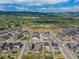 Community aerial view showcasing a circular green space and the surrounding neighborhood against a mountain backdrop at 8132 Mt Harvard Rd, Littleton, CO 80125
